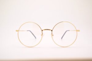 gold glasses on blank white background