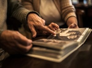 Two people looking at photo album