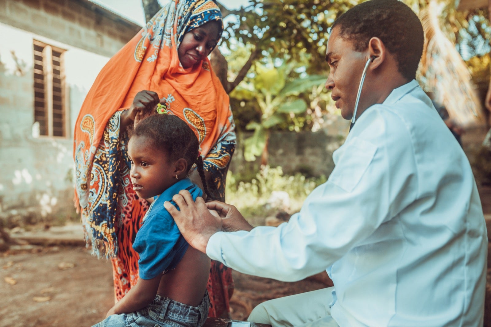 Medical provider listening to child's breath with stethoscope.