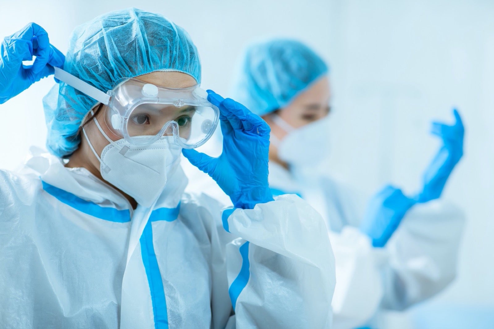 Scientists wearing protective gear.