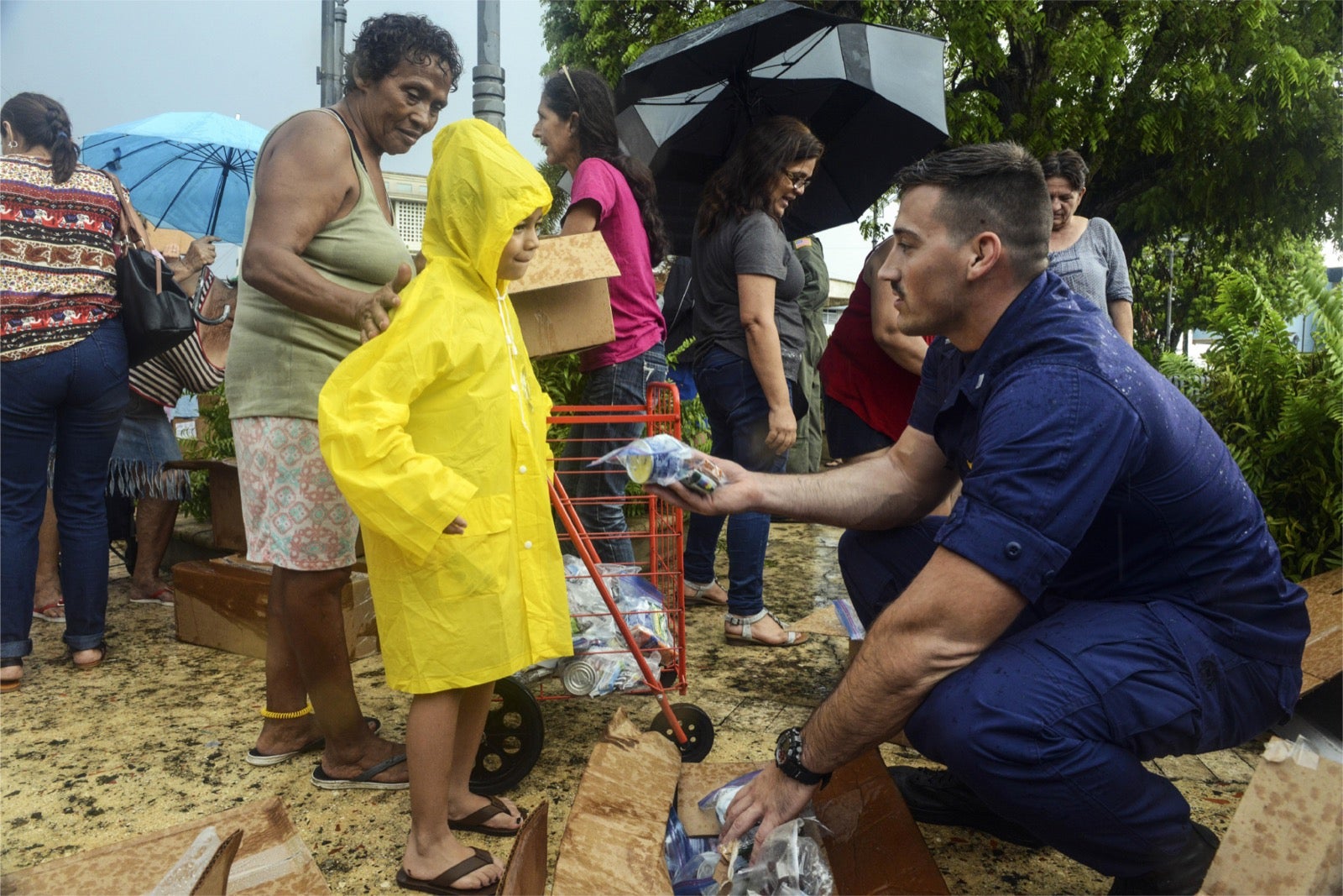 Man handing supplies to child
